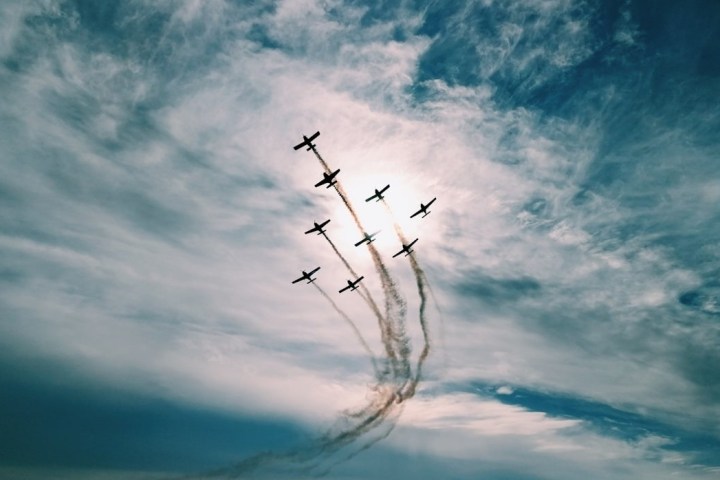 a fighter jet flying through a cloudy sky